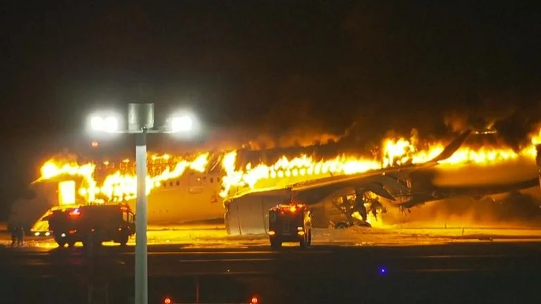 Plane catches fire on Tokyo Haneda airport runway.